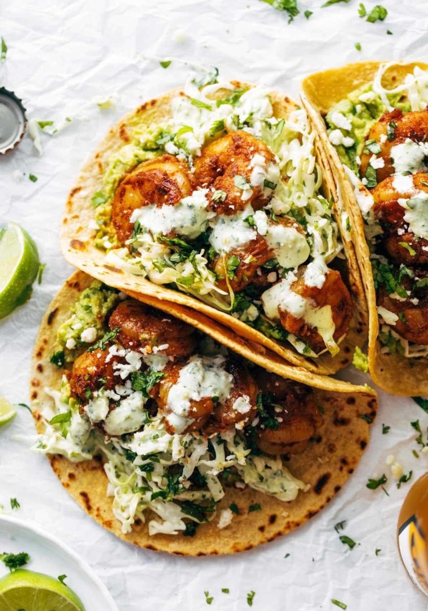 Spicy shrimp tacos with sauce.